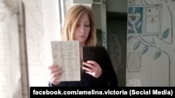 Вікторія Амеліна тримає в руках щоденник Володимира Вакуленка