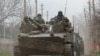 Service members of pro-Russian troops sit atop of an armoured vehicle during Ukraine-Russia conflict near the southern port city of Mariupol, Ukraine April 17, 2022. REUTERS/Alexander Ermochenko