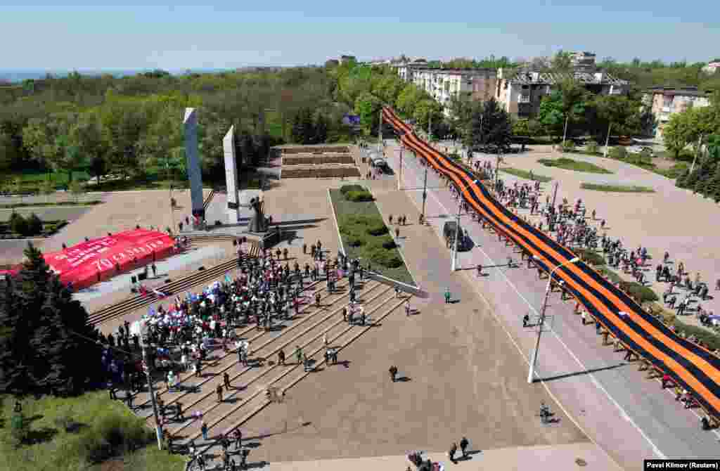 Banned by Ukraine in 2017, a 300-meter-long&nbsp;St. George&#39;s ribbon was carried through Mariupol by volunteers on May 9. Many of the participants are believed to have traveled from the separatist-held region to show their support. The St. George&#39;s ribbon has become associated with the Kremlin-backed separatists and has also been banned in Latvia, Lithuania, Moldova, and Estonia.&nbsp;