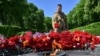 A Ukrainian soldier lays flowers at the Monument to the Unknown Soldier during Victory Day in Kyiv on May 9, 2022.