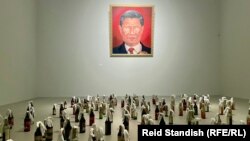 A portrait that mashes Chinese President Xi Jinping and Russian President Vladimir Putin is displayed in the DOX Center for Contemporary Art in Prague on May 12. Molotov cocktails in soy sauce bottles are on the floor.