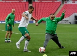  Станимир Стоилов влиза в краката на някогашния капитан на националния тим по футбол на България Стилиян Петров по време на подготовка на стадион 