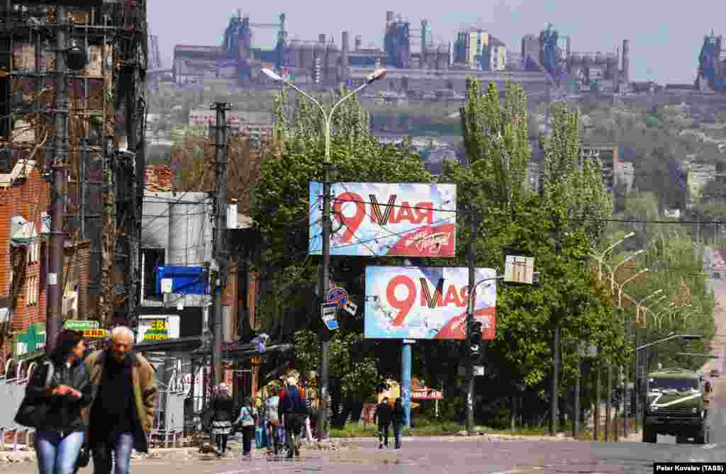 Banners celebrating the 77th anniversary of the victory over Nazi Germany in World War II are seen on the streets of a shattered Mariupol as the Azovstal steel plant stands in the background on May 9. Around 1,000 Ukrainian fighters in the besieged plant have vowed to fight on, thwarting Russia&#39;s ability to claim complete control over the Sea Of Azov port city.