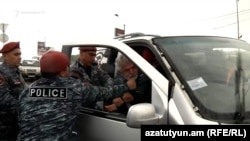 Armenia - Police arrest a participant of a motorcade rally held by the Armenian opposition in Yerevan, May 16, 2022.