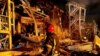 Emergency personnel work near a building damaged after a missile strike in Odesa on May 9.