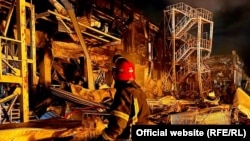 Emergency personnel work near a building damaged after a missile strike in Odesa on May 9.