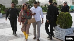 Iranian police warn a young Iranian woman about their clothing and hair during a crackdown to enforce Islamic dress code on the streets of Tehran. This latest initiative is just the latest of many aimed at forcing Iranians to conform to conservative dress codes. (file photo)