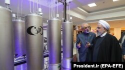 Iranian President Hassan Rohani and head of Iran's nuclear technology organisation Ali Akbar Salehi (2-R) visit a nuclear facility during the National Nuclear Technology Day in Tehran, April 9, 2019