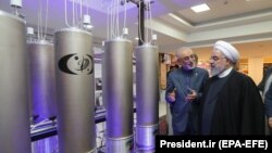 Iranian President Hassan Rouhani and head of Iran's nuclear technology organisation Ali Akbar Salehi (2-R) visit a nuclear facility during the National Nuclear Technology Day in Tehran, April 9, 2019