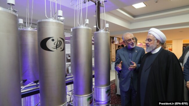 Iranian President Hassan Rouhani and head of Iran's nuclear technology organisation Ali Akbar Salehi (2-R) visit a nuclear facility during the National Nuclear Technology Day in Tehran, April 9, 2019