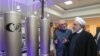 Iranian President Hassan Rohani and head of Iran's nuclear technology organization Ali Akbar Salehi (2-R) visit a nuclear facility during the National Nuclear Technology Day in Tehran, April 9, 2019