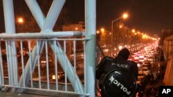 Полицейский наблюдает за демонстрантами в Тегеране
