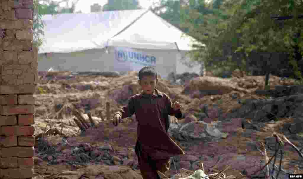 Some of the 33 million people affected by the monsoon floods in Pakistan wait for relief at a temporary shelter on the outskirts of Dera Ismail Khan district, Khyber Pakhtunkhwa, on September 28.