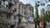 Rescuers work at the site of an apartment building damaged by a Russian military strike in Mykolayiv in southern Ukraine on October 13. 