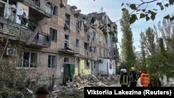 Rescuers work at the site of an apartment building damaged by a Russian military strike in Mykolayiv in southern Ukraine on October 13. 