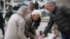 Residents in Gracanica, a majority-Serb municipality outside Kosovo's capital, sign a petition on local issues on October 3. 