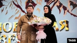 Ramzan Kadyrov and his daughter, Aishat Kadyrova, attend the opening of a folk festival in Chechnya in June 2022. 