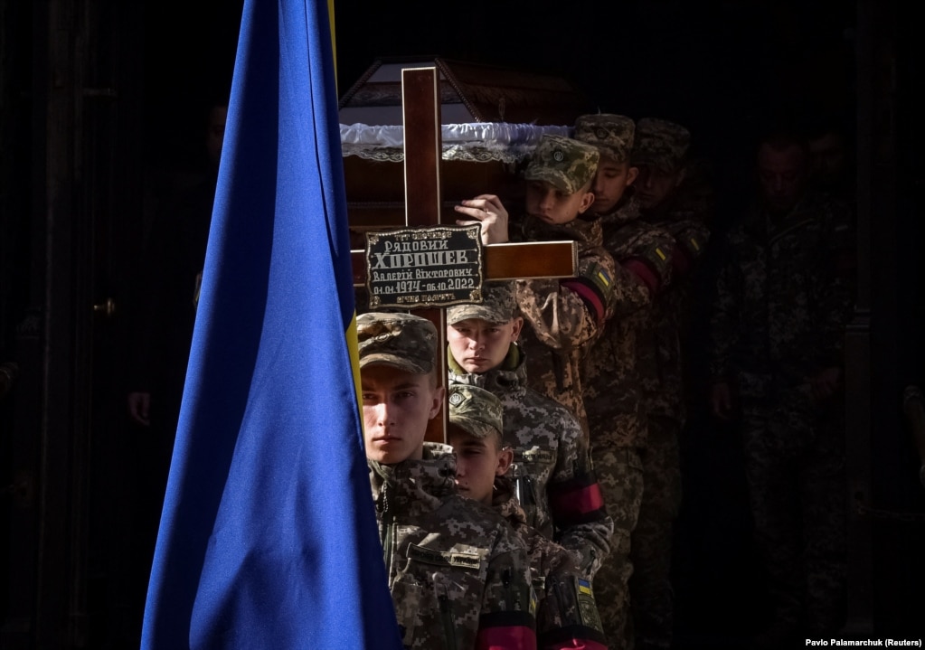 Украинские солдаты несут гроб во время похорон своего сослуживца Валерия Хорошева, недавно погибшего в бою с российскими войсками, Львов, Украина, 18 октября.