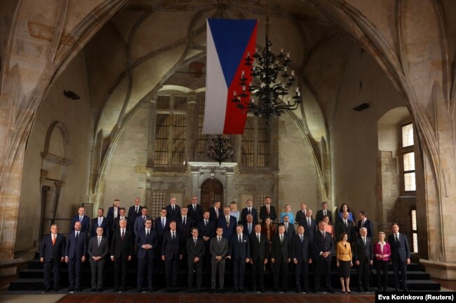 Attendees pose for a photograph at the Informal EU 27 Summit and Meeting within the European Political Community at Prague Castle.