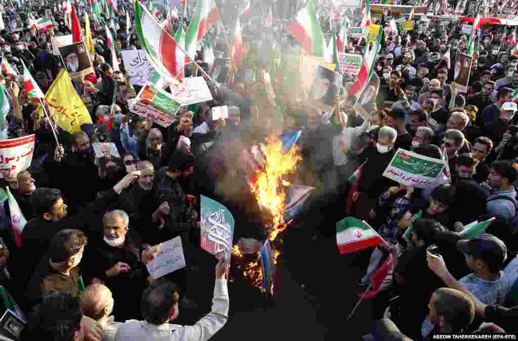 Iranians burn U.S., Israeli, and British flags as thousands take part in a massive rally against the recent anti-government protests in Iran.&nbsp;