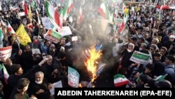 Иранцы сжигают флаги США, Израиля и Великобритании, когда тысячи проправительственных иранцев принимают участие в массовом митинге против недавних антиправительственных протестов в Иране. Тегеран. 25 сентября 2022 г.
