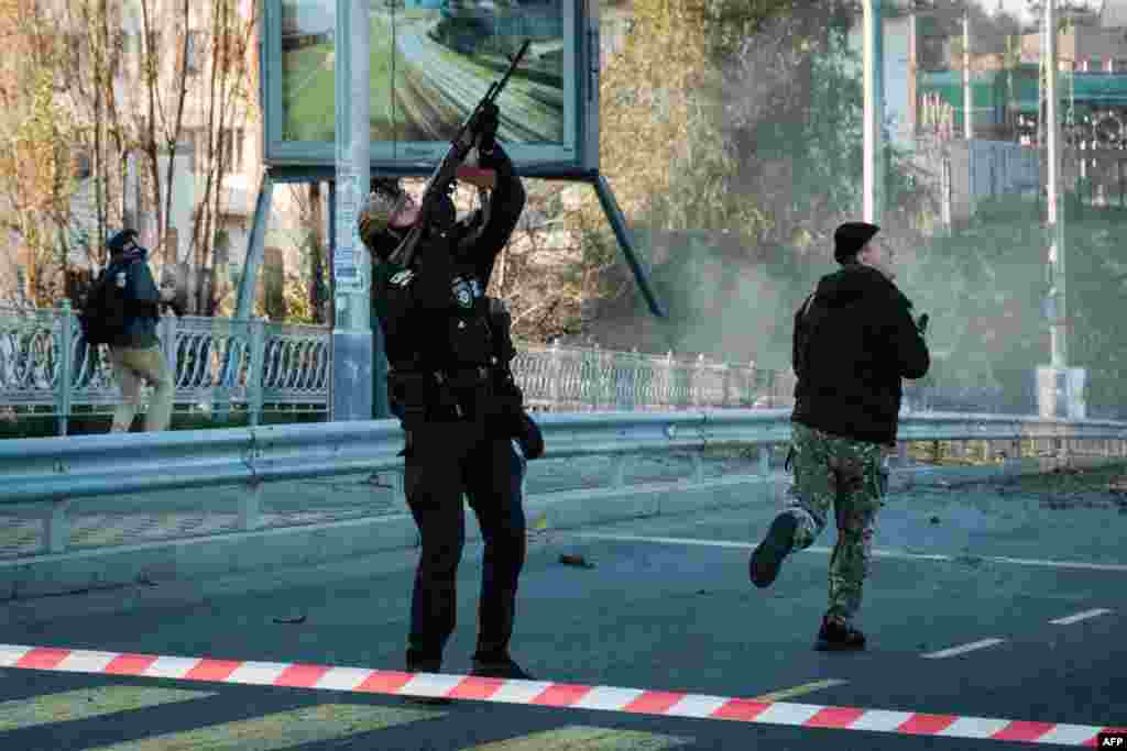A police officer fires at an incoming drone in central Kyiv.