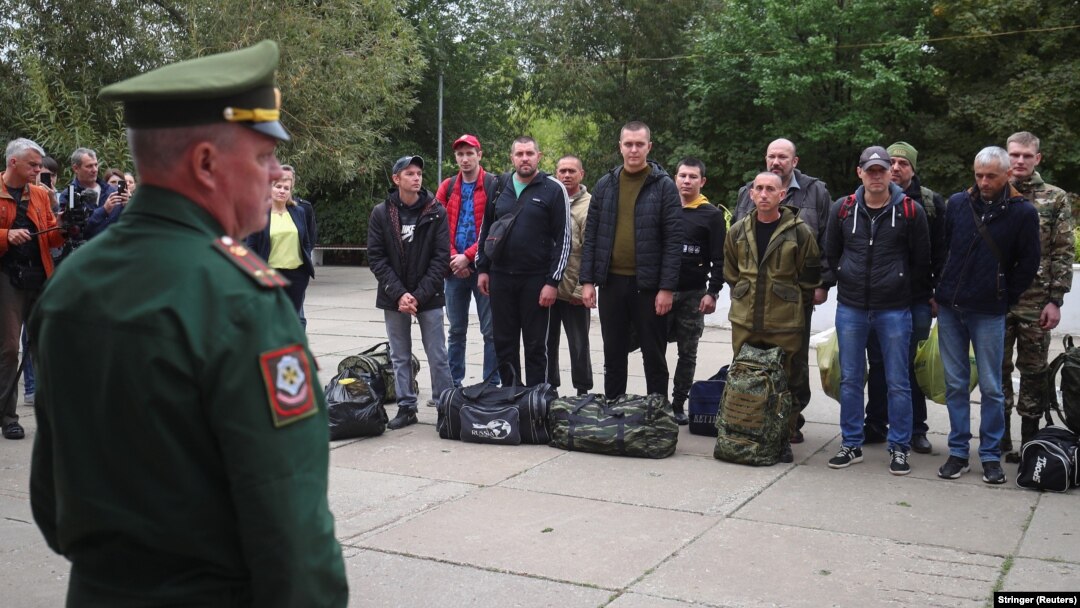 A Russian serviceman addresses reservists at a gathering point during an ongoing partial mobilization of troops, which was announced on September 21. 