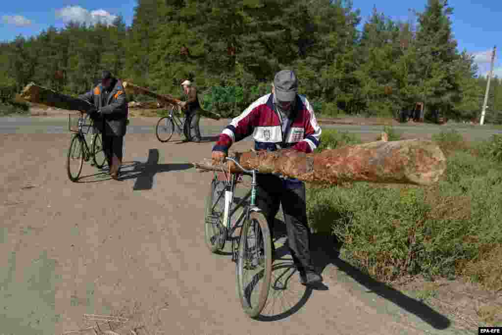 Burning wood for heat and cooking is essential for many residents, with some finding fuel by reclaiming the lumber from abandoned Russian trenches and dugouts.