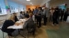 People receive their ballots at a polling station during a referendum on Ukraine's Donetsk region joining Russia in Donetsk on September 27.