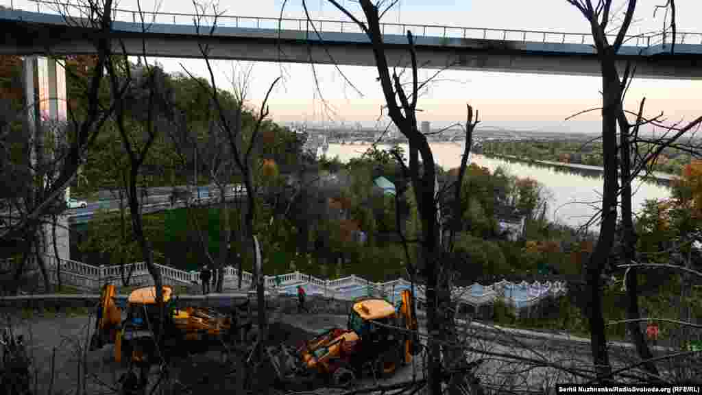 Workers remove the debris of a Russian missile that failed to destroy Kyiv&#39;s Glass Bridge.