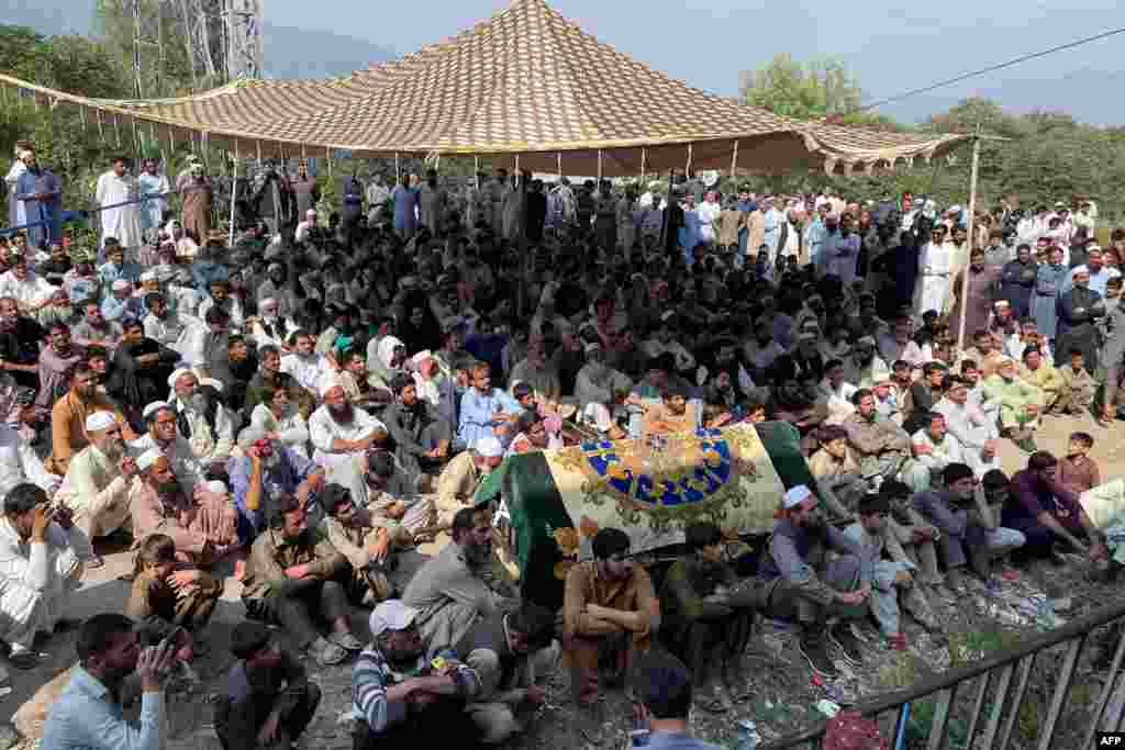 Relatives and residents take part in a protest on October 11 with the body of a school-bus driver the day after he was shot dead in an attack on his bus in Mingora, Pakistan. Up to 2,000 girls and boys walked out of school in protest of the attack.&nbsp;