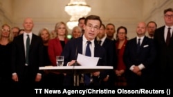 New Swedish Prime Minister Ulf Kristersson introduces the new government's ministers at a news conference in Stockholm on October 18.