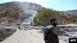 A Kurdish peshmerga fighter inspects the damage following an Iranian cross-border attack in the area of Zargwez, where several exiled left-wing Iranian Kurdish parties maintain offices, around 15 kilometers from the Iraqi city of Sulaymaniyah on September 28.