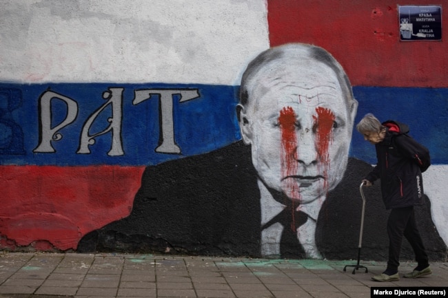 A mural of Russian President Vladimir Putin with the word 'Brother' written on it, which has been vandalized with red spray paint, in Belgrade. -  Ukraine War