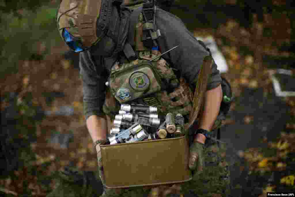 A Ukrainian territorial defense member removes munitions from an automatic grenade launcher in the Hrakove position. In September, locals told AP that there was no indication Russian troops were about to abandon the village, which is around 6 kilometers from the Russian border. &quot;Nobody knew anything. They left very quietly,&rdquo; said Vyacheslav Myronenko, 71, who survived in the basement of his bombed-out apartment building with three neighbors for more than four months.&nbsp;