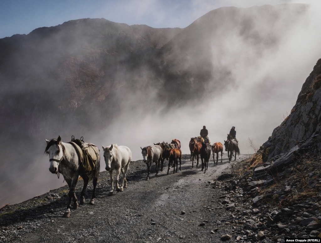 Ididze and horse caretaker Irakli Kotilaidze drive horses up the only road out of the Tusheti highlands.