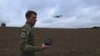 Instructor Ilya Trokhin demonstrates the controls of an unmanned aircraft at the Kruk drone school in Kyiv. 