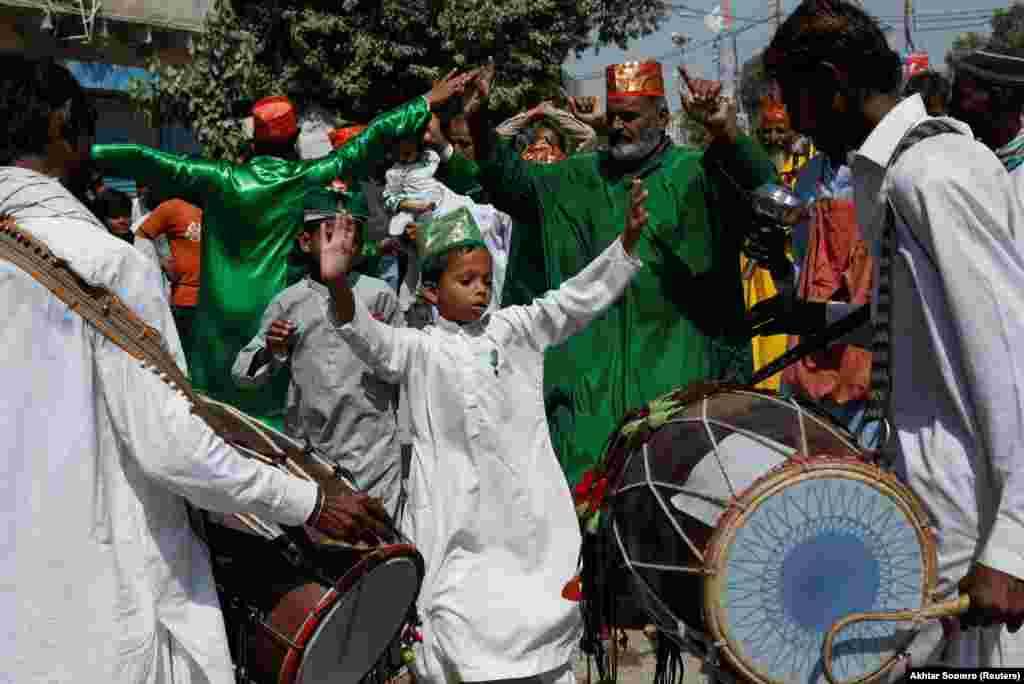 A boy performs a dance called &quot;dhamal&quot; with others during the celebrations to mark the birth anniversary of the Prophet Muhammad in Karachi, Pakistan, on October 9.