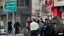 Iranian female protesters are manhandled by security forces at a demonstration in October in the city of Rasht, in Iran's northern Gilan Province, whose governor has now been added to an EU sanctions list. 