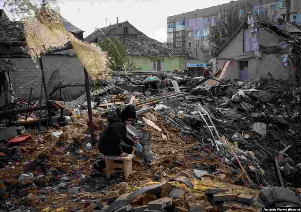 A boy plays in the ruins of his grandmother&#39;s house.