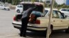 Turkmenistan. Man taking bread in the car trunk. September 2022
