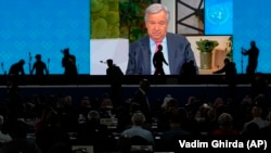 Participants watch a recorded message from UN Secretary-General Antonio Guterres during the opening session of the International Telecommunication Union in Bucharest on September 26.
