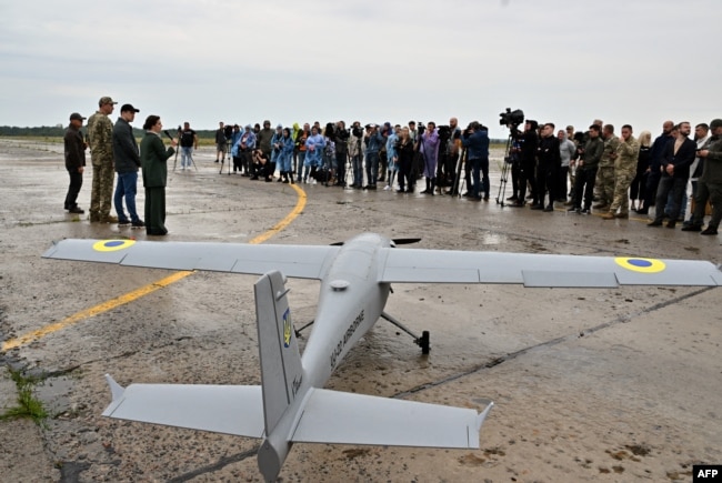 Journalists attend the presentation of a UJ-22 reconnaissance drone in the Kyiv region in August 2022.