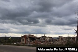 Mykola Myronenko's destroyed grocery and household goods shop in Dolyna, eastern Ukraine