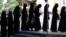 Afghan female students queue for entrance exams at Kabul University on October 13. The Taliban has issued restrictions controlling women's lives, blocking girls from returning to secondary schools and barring women from many government jobs.