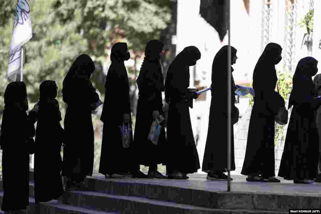 Female Afghan students stand in line after they arrive for entrance exams at Kabul University.