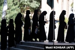 Female students stand in line after they arrive for entrance exams at Kabul University in Kabul in October.
