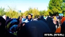 A Taliban fighter tries to disperse a protest by university students in the western Afghan province of Herat.