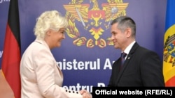 German Defense Minister Christine Lambrecht shakes hands with her Moldovan counterpart Anatolie Nosatîi during a visit to Chișinau on October 1.