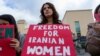 زنی با پوستری در یک تجمع اعتراضی در حمایت از زنان ایران که روی آن نوشته است: «آزادی برای زنان ایرانی»